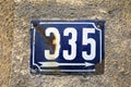 Number 335 number of houses apartments streets. White number of blue metal plate house number three hundred and thirty-five 335 Royalty Free Stock Photo